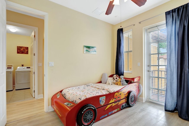 bedroom featuring ceiling fan, light wood-type flooring, and washer / clothes dryer