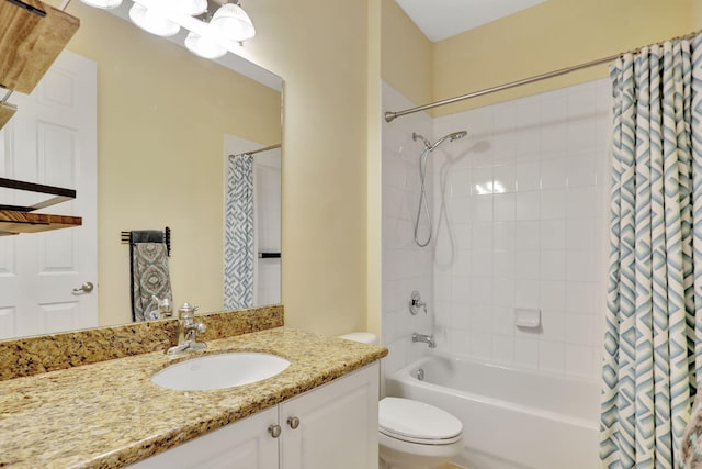 full bathroom with vanity, shower / bath combo with shower curtain, and toilet