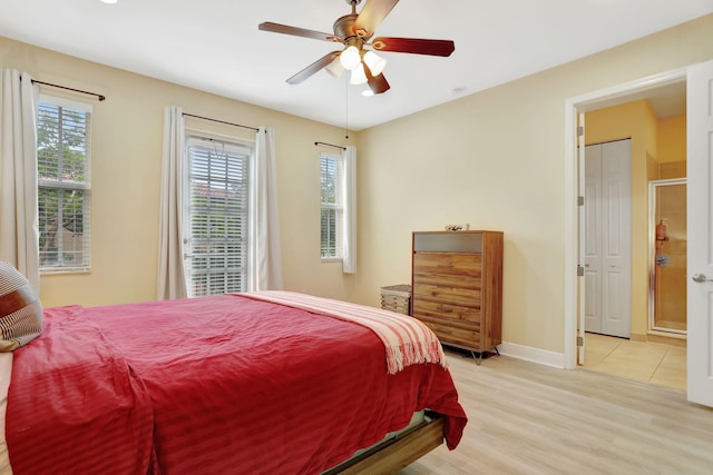 bedroom featuring multiple windows, light wood-type flooring, and ceiling fan