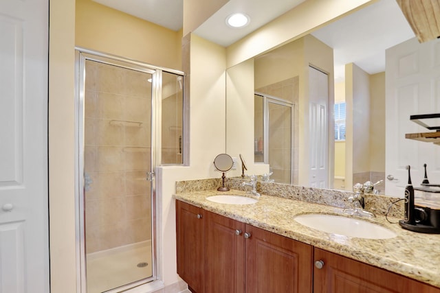 bathroom featuring vanity and an enclosed shower