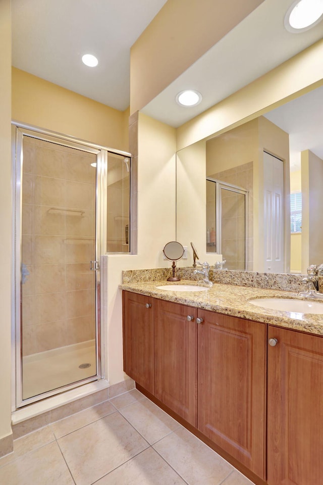 bathroom with vanity, tile patterned floors, and a shower with shower door