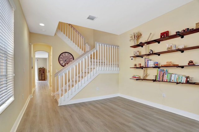 stairway with hardwood / wood-style flooring