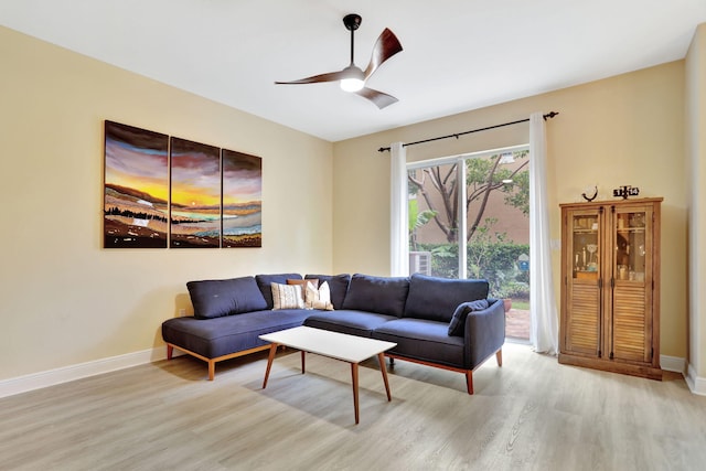 living room featuring light wood-type flooring and ceiling fan