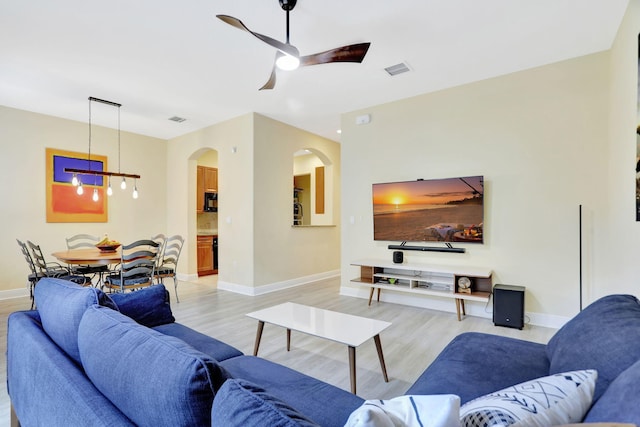 living room featuring ceiling fan and light wood-type flooring