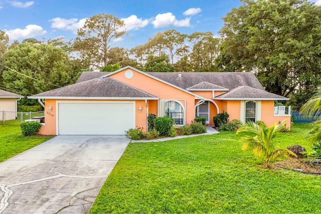 single story home featuring a front yard and a garage