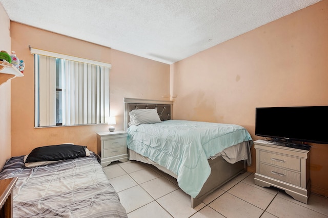 tiled bedroom with a textured ceiling