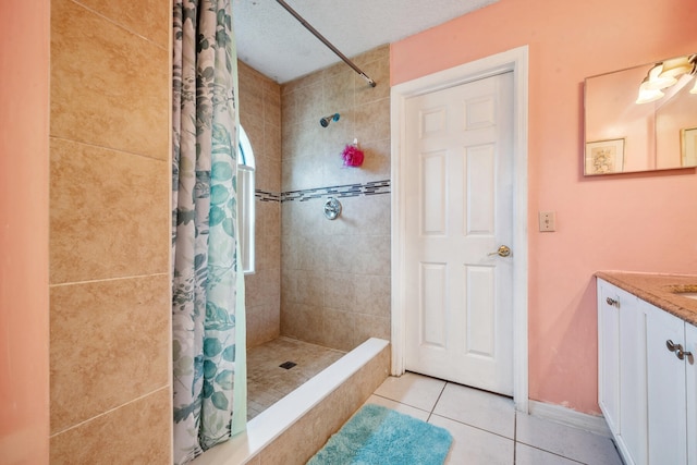 bathroom featuring vanity, tile patterned floors, walk in shower, and a textured ceiling