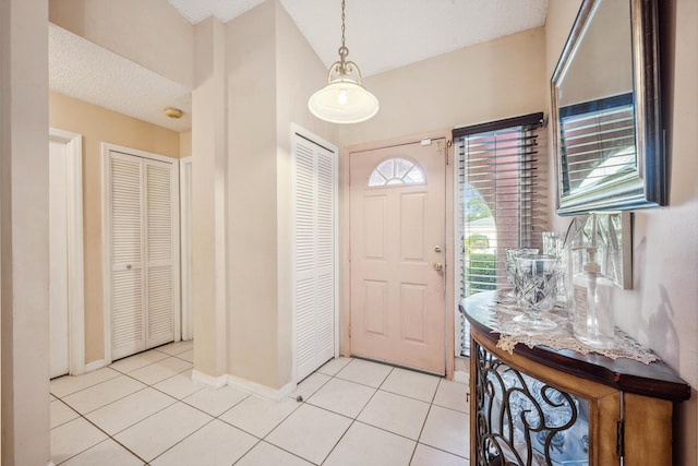 tiled entryway featuring a textured ceiling