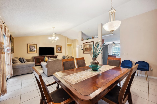 tiled dining room featuring a textured ceiling, vaulted ceiling, and ceiling fan with notable chandelier