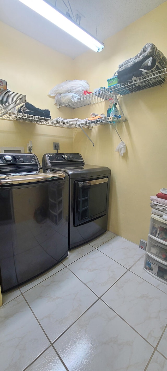 clothes washing area with separate washer and dryer