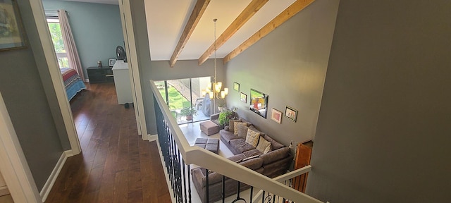 hall with a chandelier, lofted ceiling with beams, and dark wood finished floors