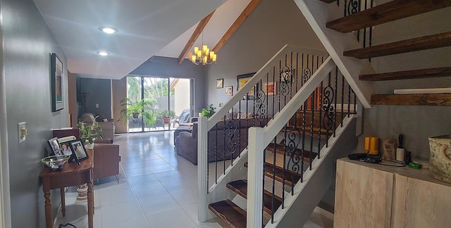 stairway with tile patterned flooring, vaulted ceiling, and a notable chandelier