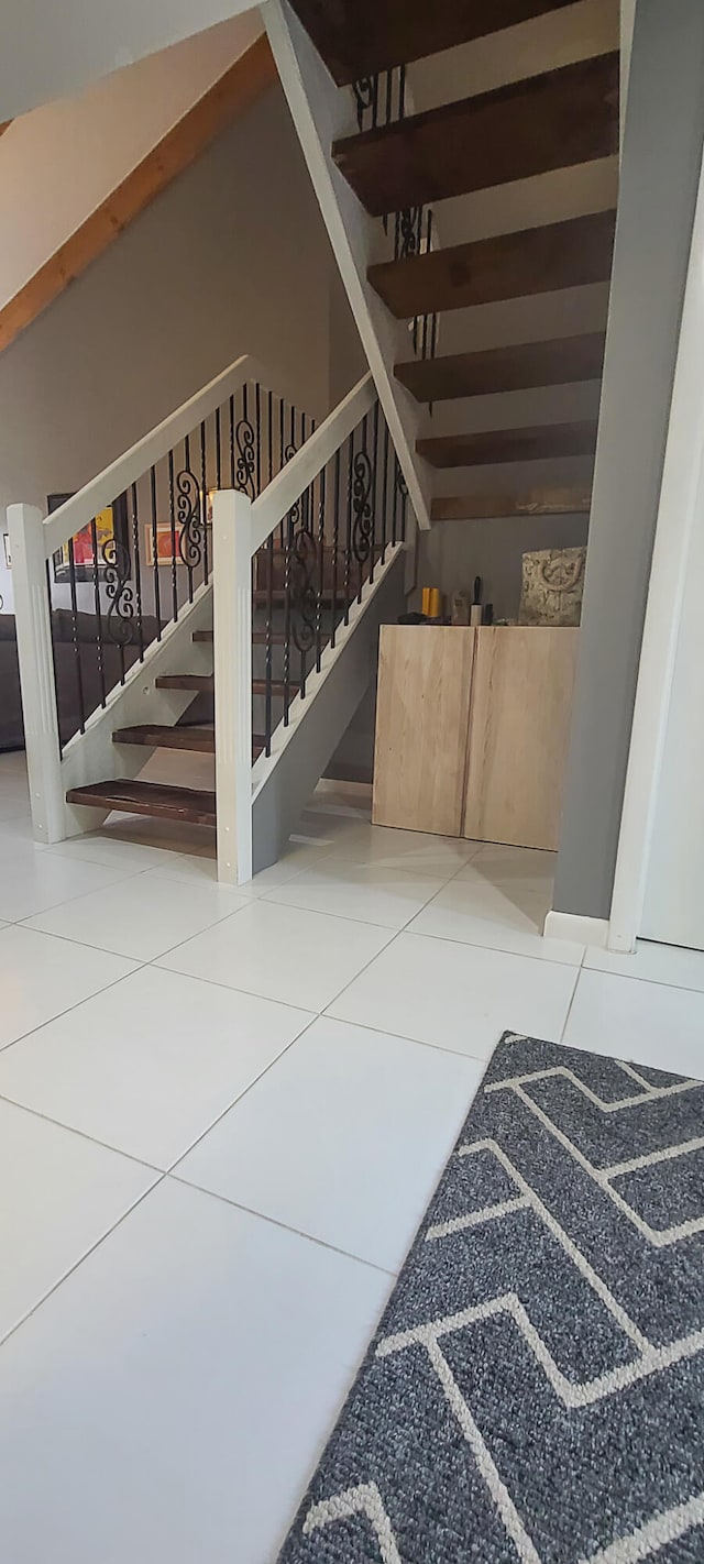 stairway featuring tile patterned floors