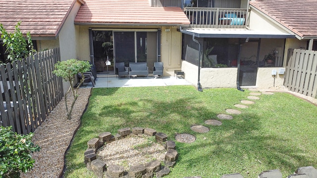 back of property featuring a patio and a lawn