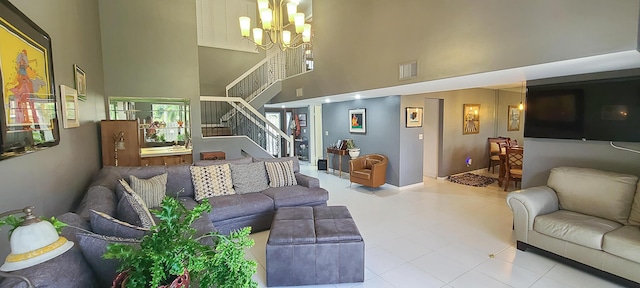 living area featuring visible vents, baseboards, a high ceiling, stairway, and a chandelier
