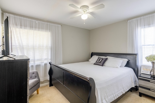 bedroom featuring light carpet and ceiling fan