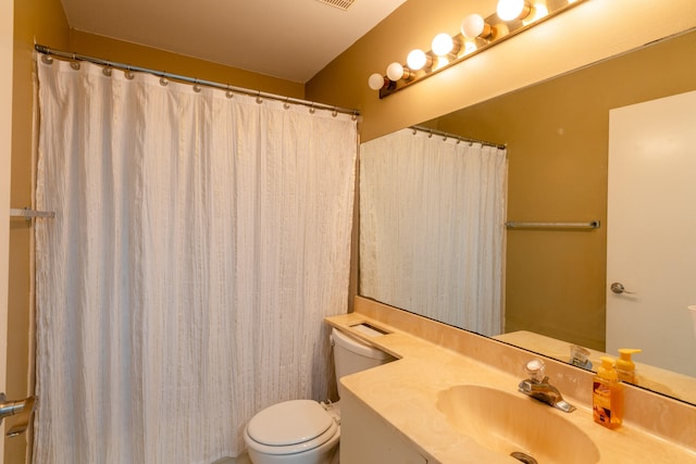 bathroom with toilet and vanity