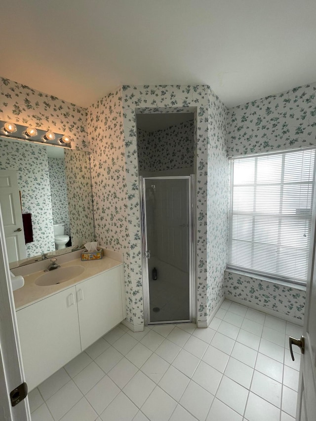 bathroom with vanity, walk in shower, and tile patterned floors