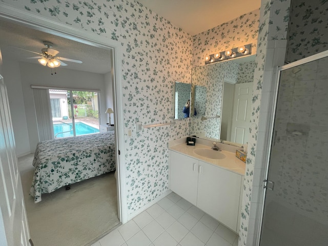 bathroom with a textured ceiling, an enclosed shower, ceiling fan, tile patterned floors, and vanity