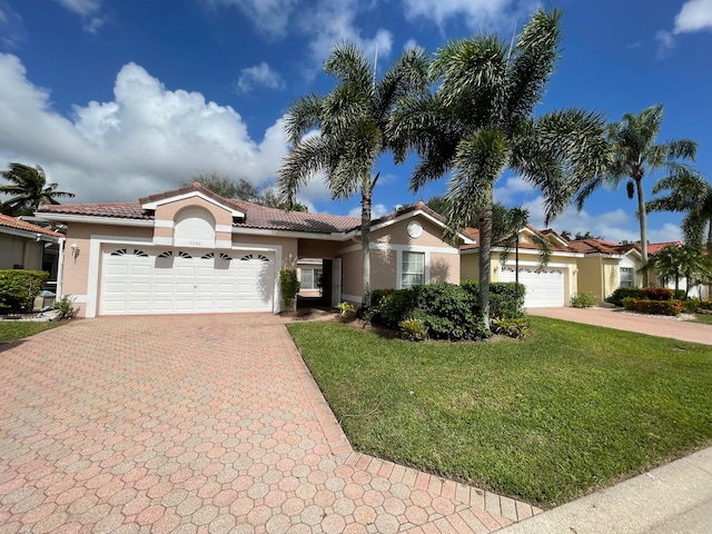 view of front of property with a garage and a front lawn