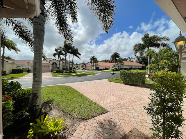 view of home's community with a yard and a garage