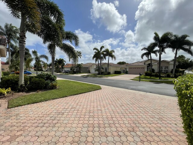 mediterranean / spanish-style house with a front lawn and a garage