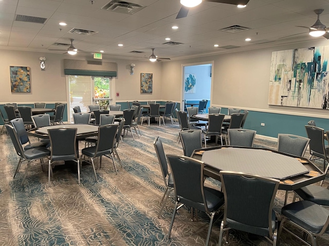 carpeted dining area featuring ornamental molding and ceiling fan