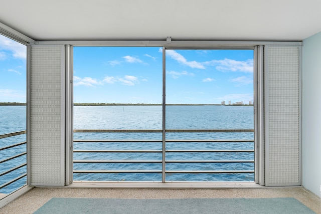 unfurnished sunroom with a water view