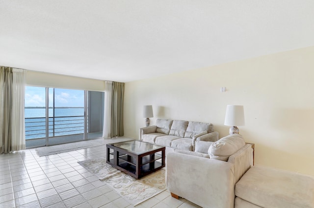 tiled living room featuring a water view