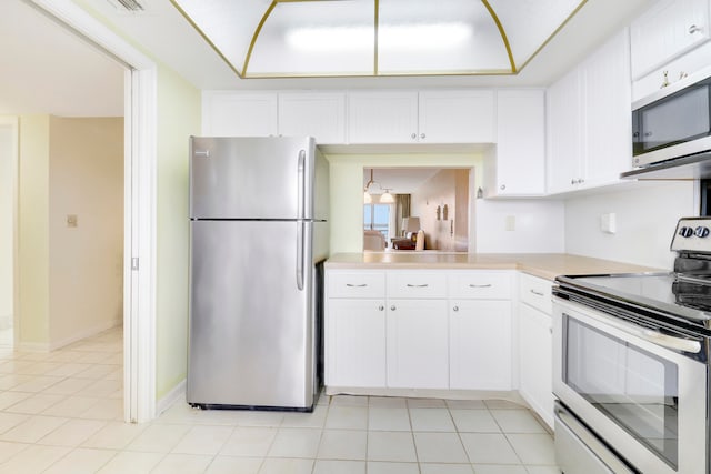 kitchen with white cabinets, stainless steel appliances, and light tile patterned flooring