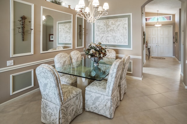 tiled dining space featuring a notable chandelier and vaulted ceiling