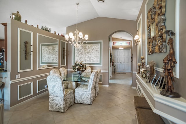 tiled dining area with an inviting chandelier and lofted ceiling