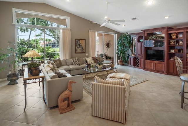 living room with lofted ceiling, light tile patterned floors, and ceiling fan