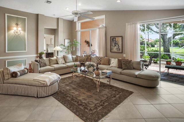 living room featuring ceiling fan, light tile patterned flooring, and lofted ceiling