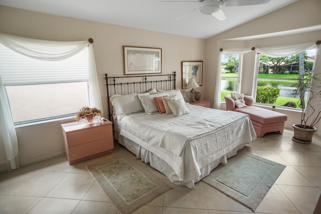 bedroom featuring lofted ceiling, light tile patterned floors, and ceiling fan