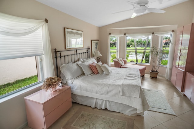 bedroom with lofted ceiling, light tile patterned floors, and ceiling fan