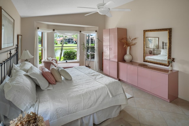 bedroom with ceiling fan, lofted ceiling, and light tile patterned floors