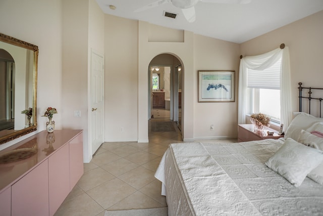 tiled bedroom with ceiling fan and lofted ceiling