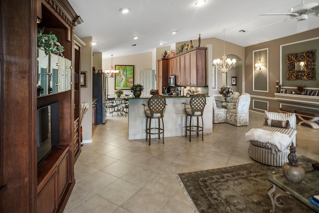 living room featuring light tile patterned floors, lofted ceiling, and ceiling fan