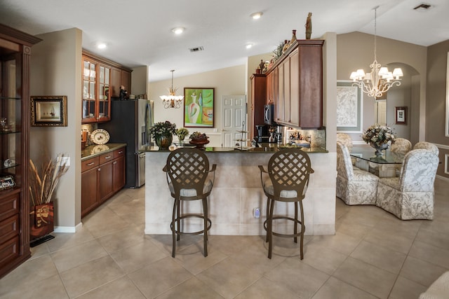 kitchen with lofted ceiling, stainless steel appliances, and plenty of natural light