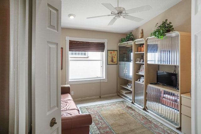 interior space featuring a textured ceiling and ceiling fan