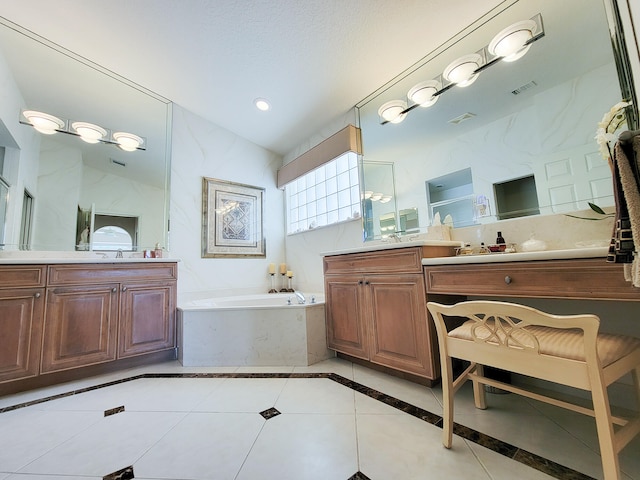 bathroom featuring lofted ceiling, tile patterned flooring, a bathing tub, vanity, and a textured ceiling