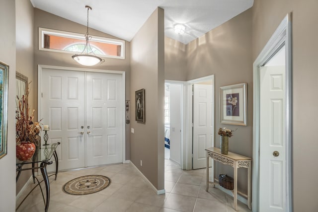 tiled entryway with high vaulted ceiling