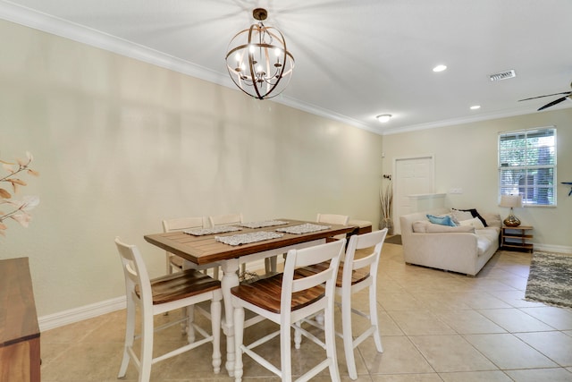 tiled dining area with ornamental molding and ceiling fan with notable chandelier