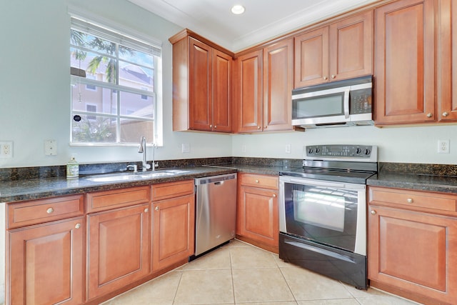 kitchen with light tile patterned floors, stainless steel appliances, and sink