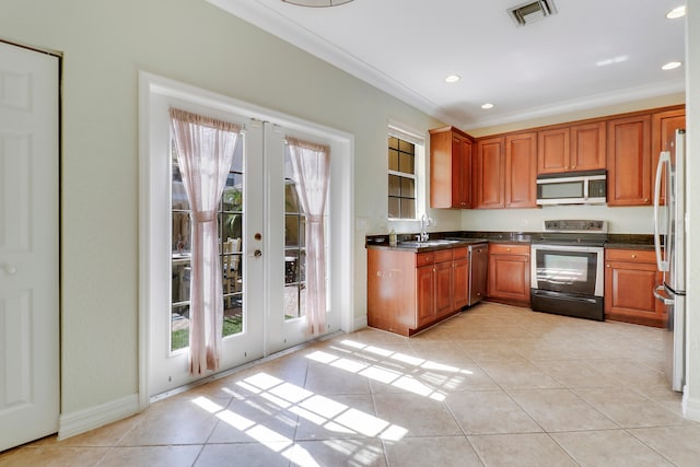 kitchen featuring french doors, ornamental molding, sink, light tile patterned flooring, and appliances with stainless steel finishes