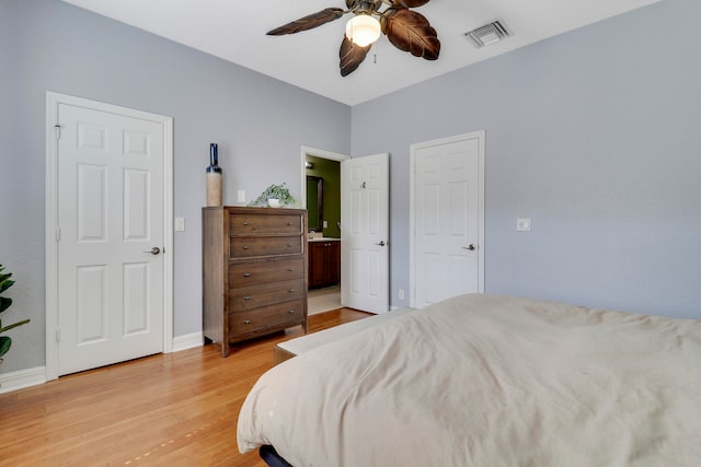 bedroom with connected bathroom, light hardwood / wood-style floors, and ceiling fan