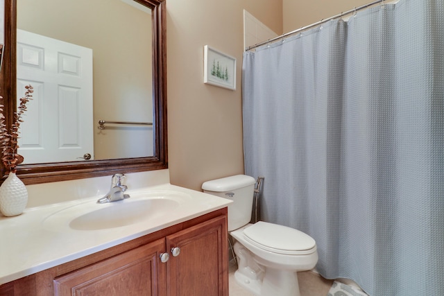 bathroom with vanity, toilet, and tile patterned floors