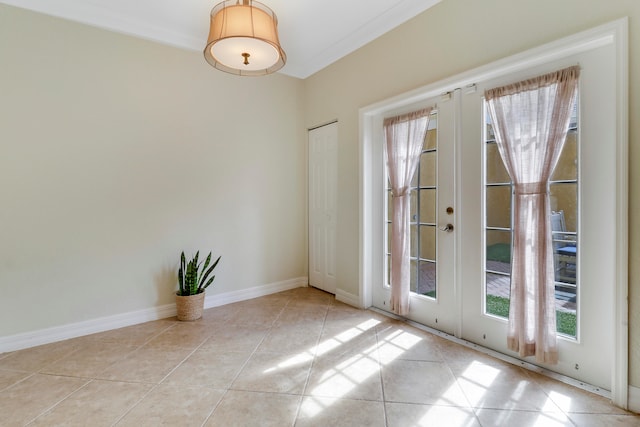 interior space featuring french doors, crown molding, and light tile patterned floors