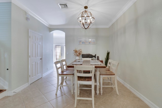 dining room with crown molding, light tile patterned flooring, and a chandelier